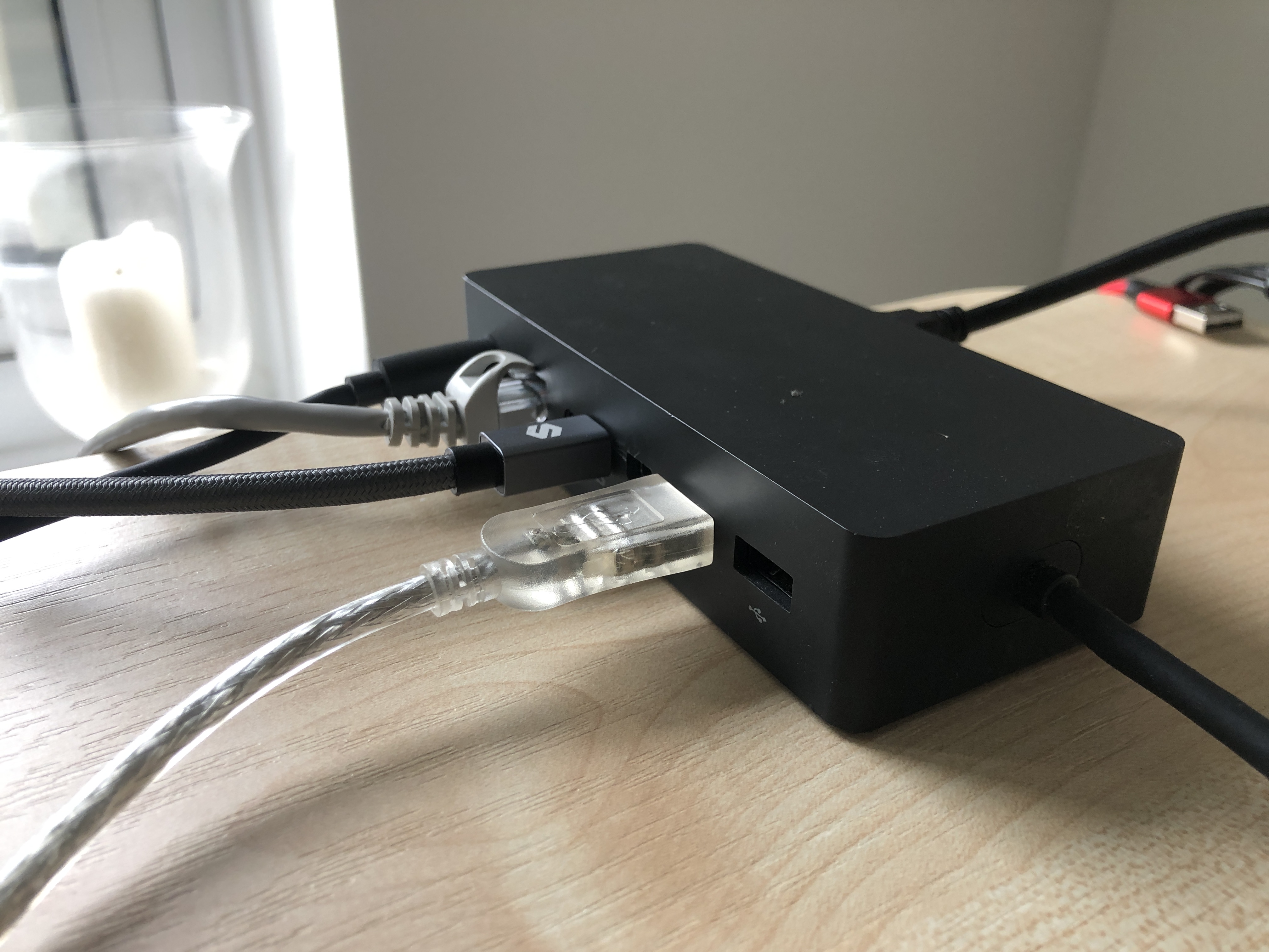 New style Surface dock on a desk, with cables plugged into it