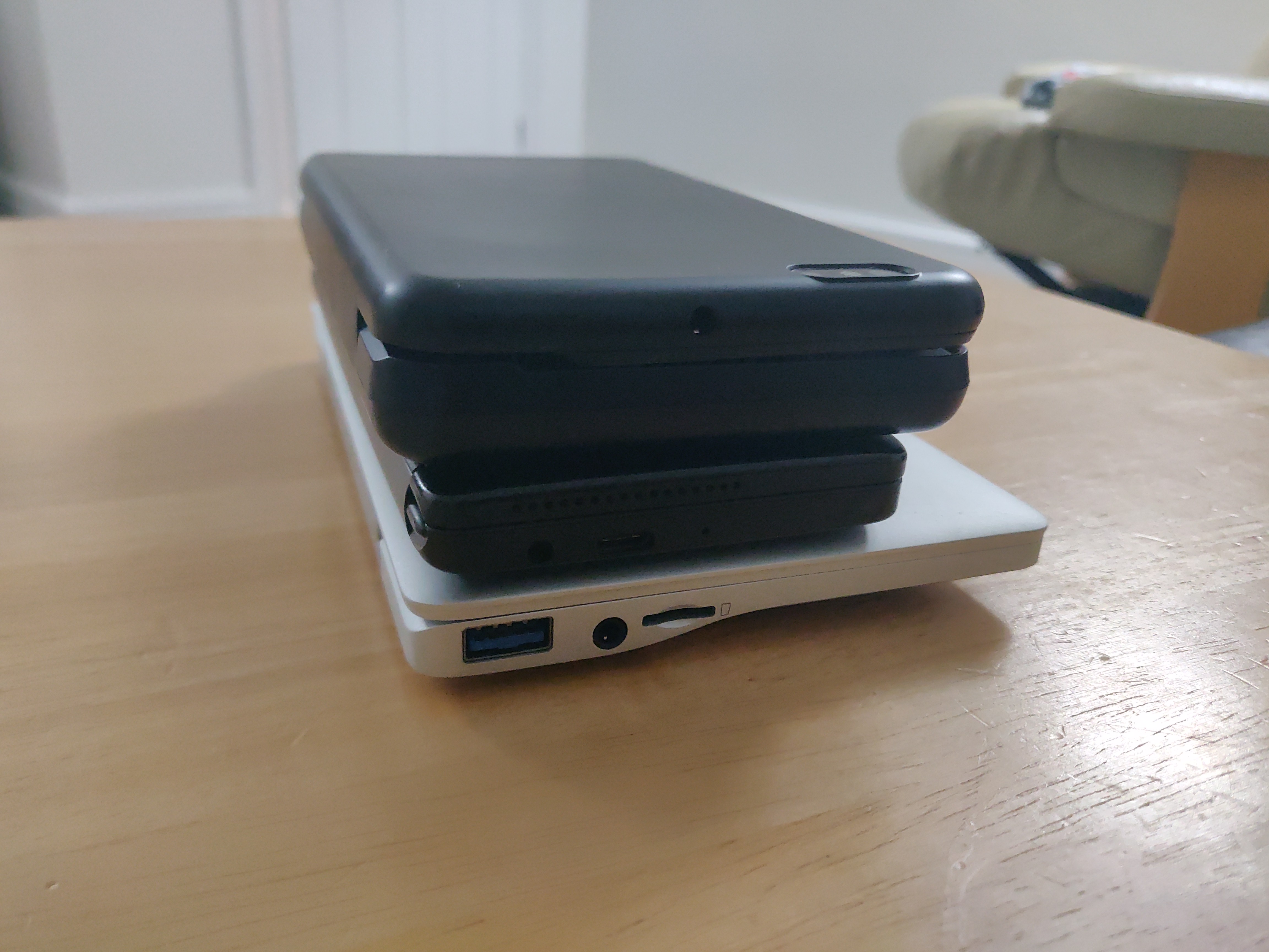 Photo showing PinePhone Pro in keyboard case, on top of Planet Gemini, on top of GPD Pocket 2