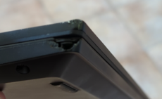 A cracked corner on a black ThinkPad